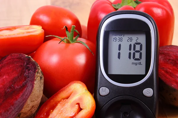 Vegetables and glucose meter on wooden surface, healthy lifestyle, nutrition, diabetes