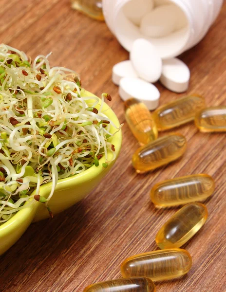 Alfalfa and radish sprouts with tablets supplements, healthy nutrition