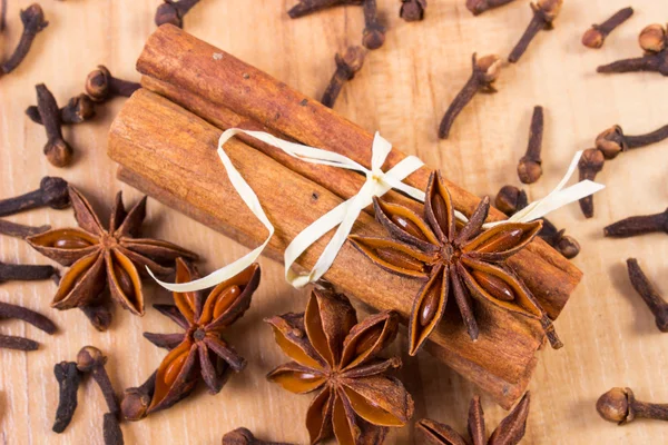 Star anise, cinnamon sticks and cloves on wooden table, seasoning for cooking