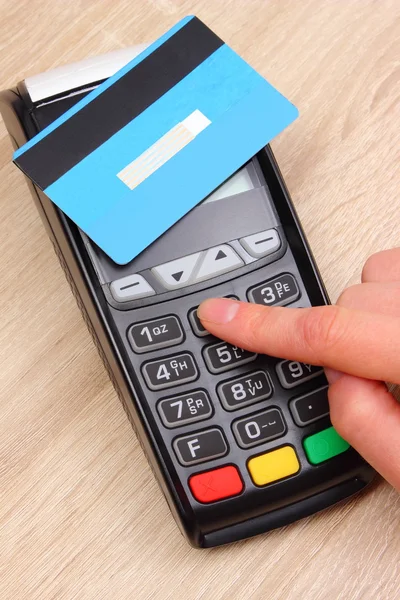 Hand of woman using payment terminal, enter personal identification number