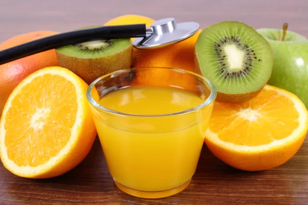 Stethoscope, fresh fruits and juice, healthy lifestyles and nutrition