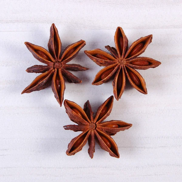 Star anise spice on white wooden table
