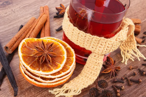 Glass of mulled wine wrapped scarf with fresh fragrant spices