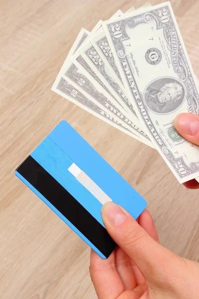 Currencies dollar and credit card in hand, finance concept