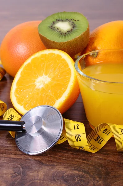 Stethoscope, fresh fruits, juice and centimeter, healthy lifestyles and nutrition