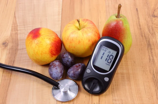 Glucose meter with medical stethoscope and fresh fruits, healthy lifestyle
