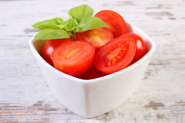 Cherry tomatoes with basil in glass bowl, healthy food and nutrition