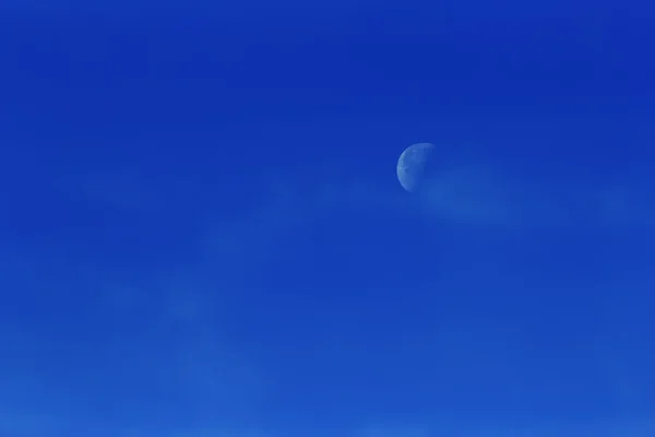 Moon in the afternoon on blue sky