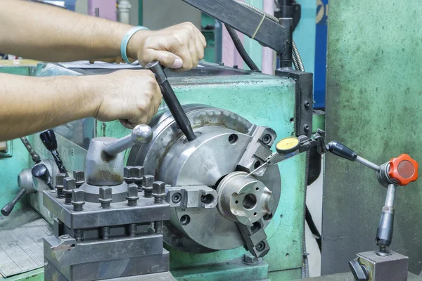 Operator setup turning part on manual lathe machine