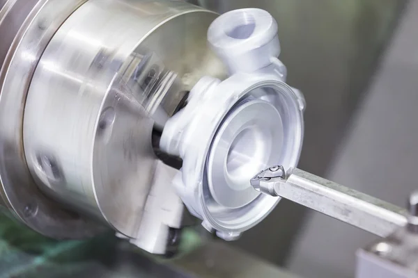 Operator turning automotive parts by cnc lathe