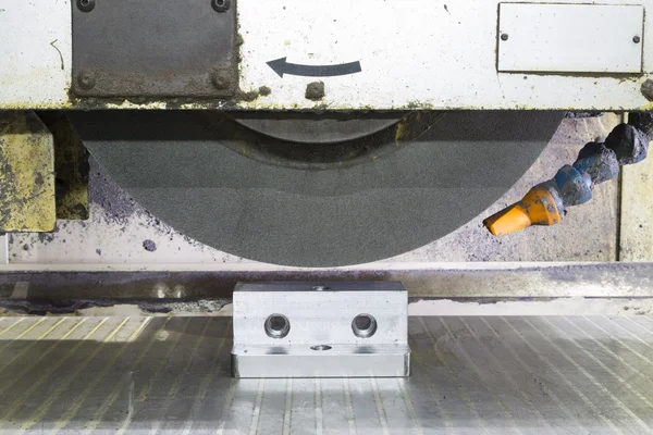 Operator grinding surface of mold and die parts