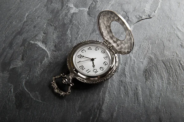Pocket gray clock on dark gray