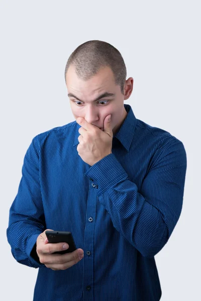 Shocked man browsing his smartphone