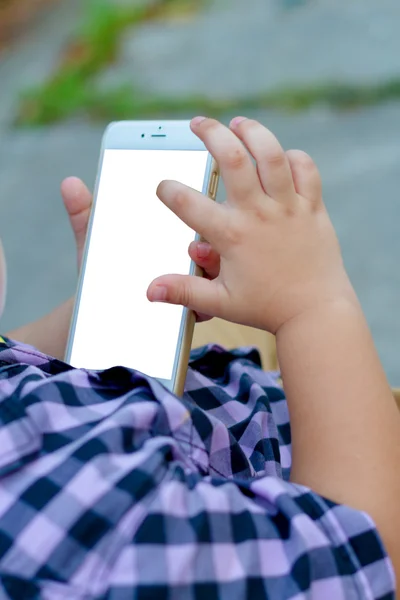 Little boy child kid playing games on smartphone mobile phone