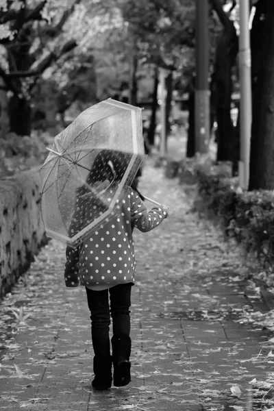 Girl walk alone with umbrella