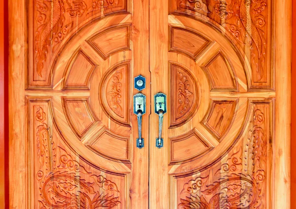 Wooden door decorated with modern style metallic door handle on