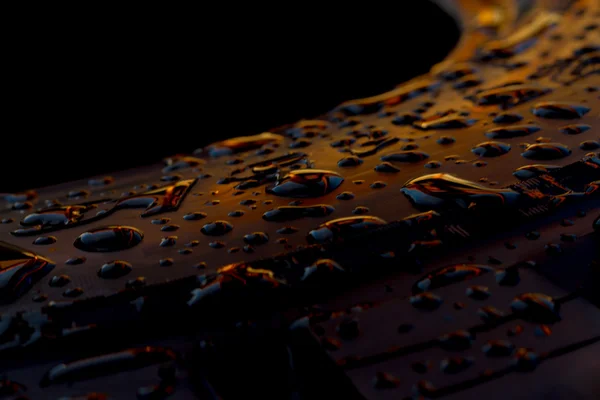 Abstract of Dew drops on a tire after rain with the light of sun