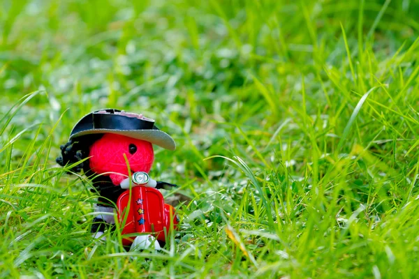 Alone concept: the doll was left alone in the grass.