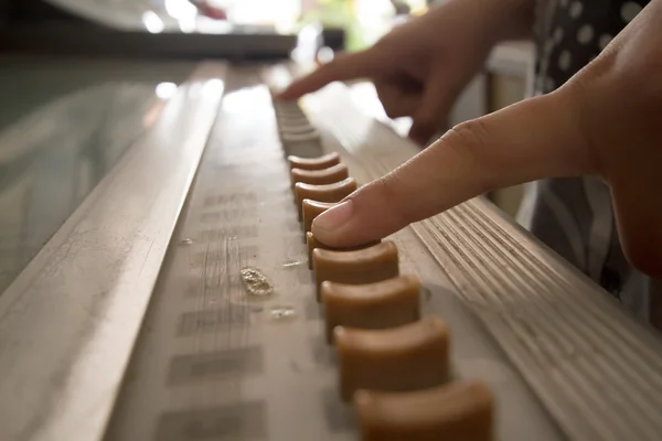 Finger press on the playing ancient music machine