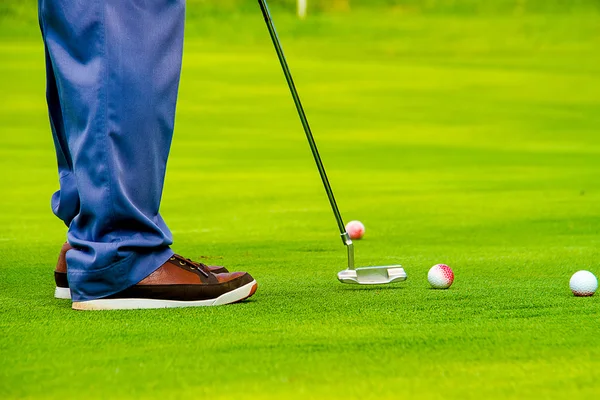 The winner : close up of man playing golf and putting ball with