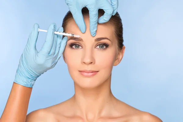 Beauty woman giving botox injections.