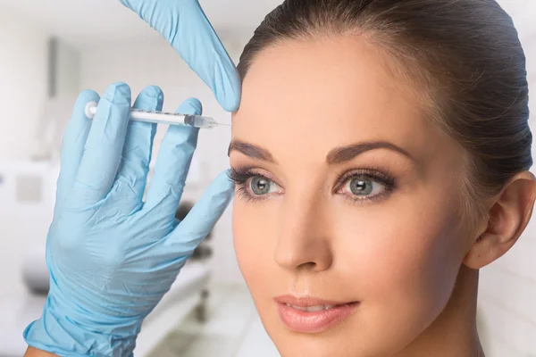 Beauty woman giving botox injections.