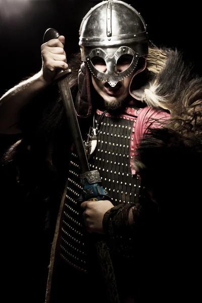 Shouting viking with sword and helmet over black background