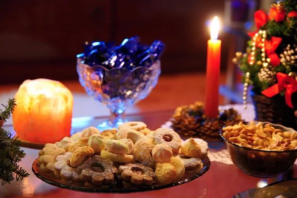 Christmas sweets with candle on the table