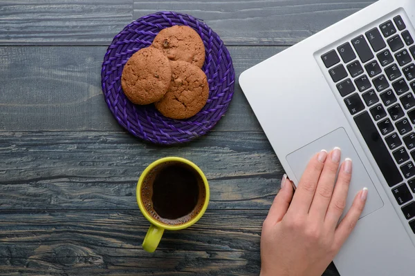 Laptop with coffee and cookies