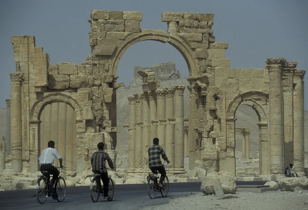 People riding bicycle near Roman Ruins