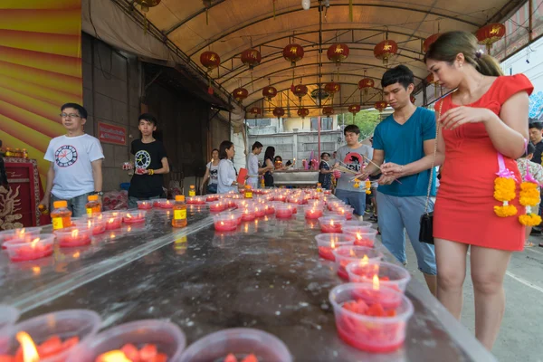 Thai people pray in Chinese temple