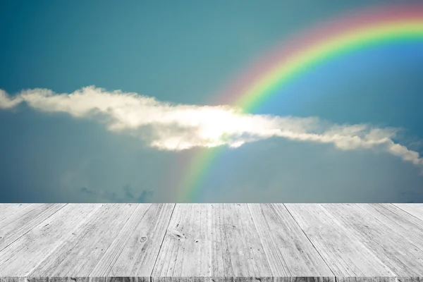 Blue sky cloud with Wood terrace and rainbow , process in vintag