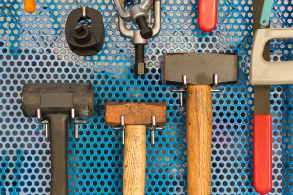 Collection of hammer tools tidy on board in garage