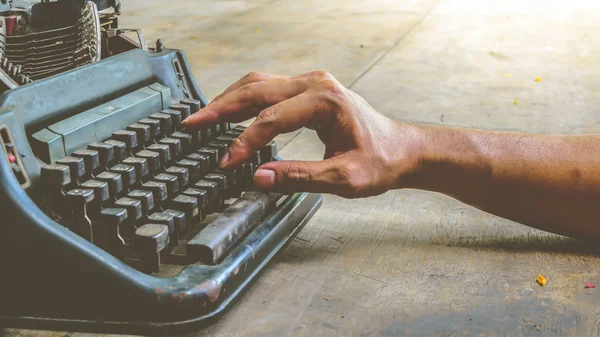Typewriter and human hand , vintage style