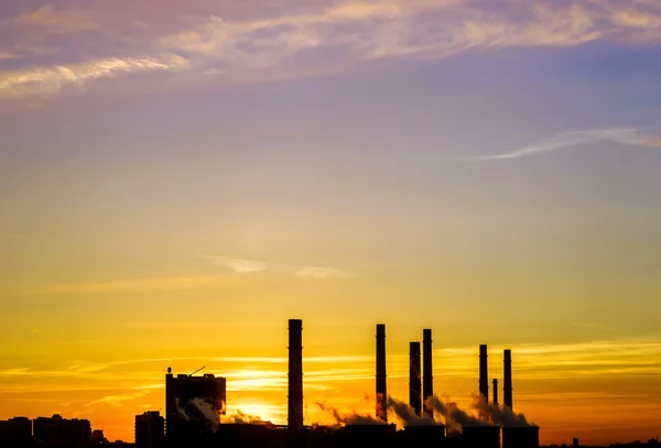Central heating and power plant on beautiful colorful sunset background