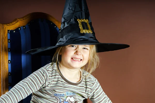 Cute little girl posing in halloween hat