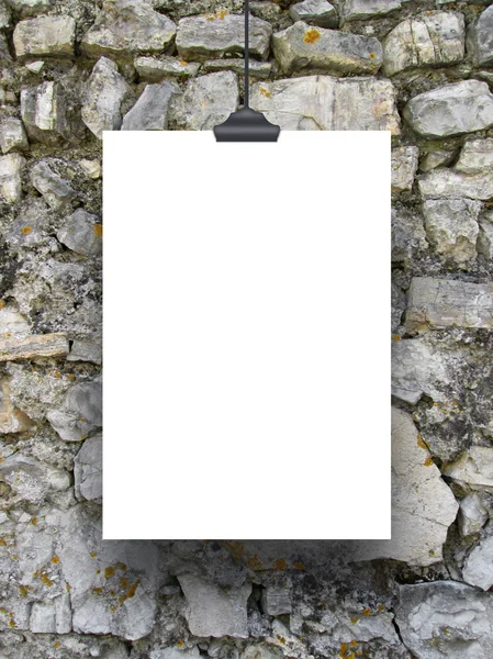 Single hanged paper sheet with clip on Italian medieval stone wall