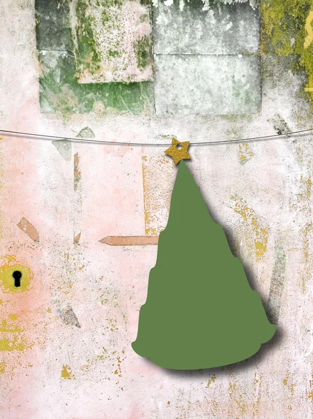 Single hanged Christmas tree shaped frame with star on grungy scratched concrete wall