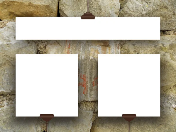 Three hanged square and rectangular frames on ancient stone wall