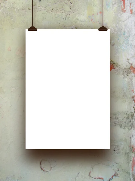 Single hanged paper sheet with clips on stained concrete wall