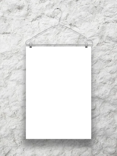 Single hanged paper sheet with clothes hanger on grey plastered wall