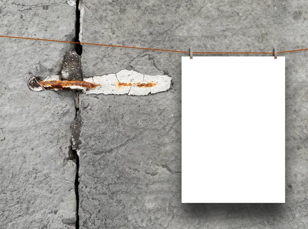 Vertical frame hung by clothes pin on cracked stone wall