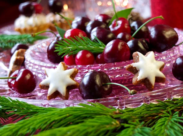 Christmas dessert - red berries cherries, cranberries and christmas tweeg