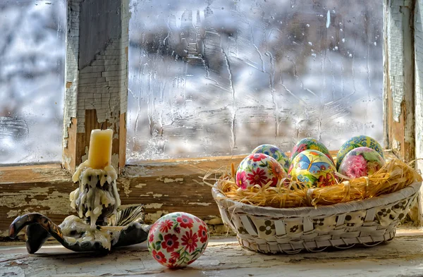 Basket with Easter eggs on the windowsill.