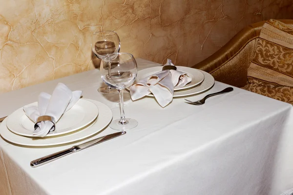 Elegant table setting with cutlery under natural light, as a blank for a point of stage design.