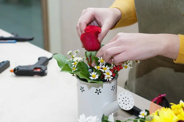 Florist making a composition of different cut flowers