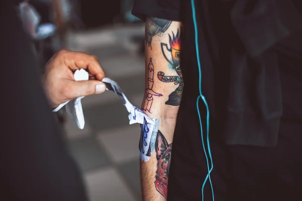 Master tattoo artist showing process