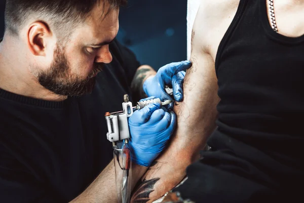 Master tattoo artist with a beard