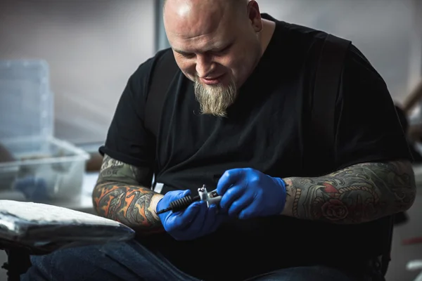 Master tattoo artist prepares tools