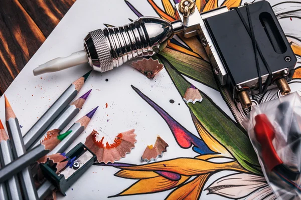 Beautiful sketch drawing flowers with colored pencils lying on old wooden background
